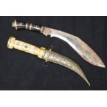A Dagger with a decorated bone handle and a Kukri