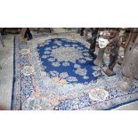 A Large Persian Blue ground Kirman Rug. 396cm x 304cm