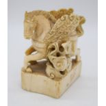 A Chinese Ivory seal in the form of a winged horse 6 x 7.5 cm