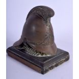 AN ANTIQUE EUROPEAN BRONZE FIREMAN'S HELMET PAPERWEIGHT. 14 cm wide.