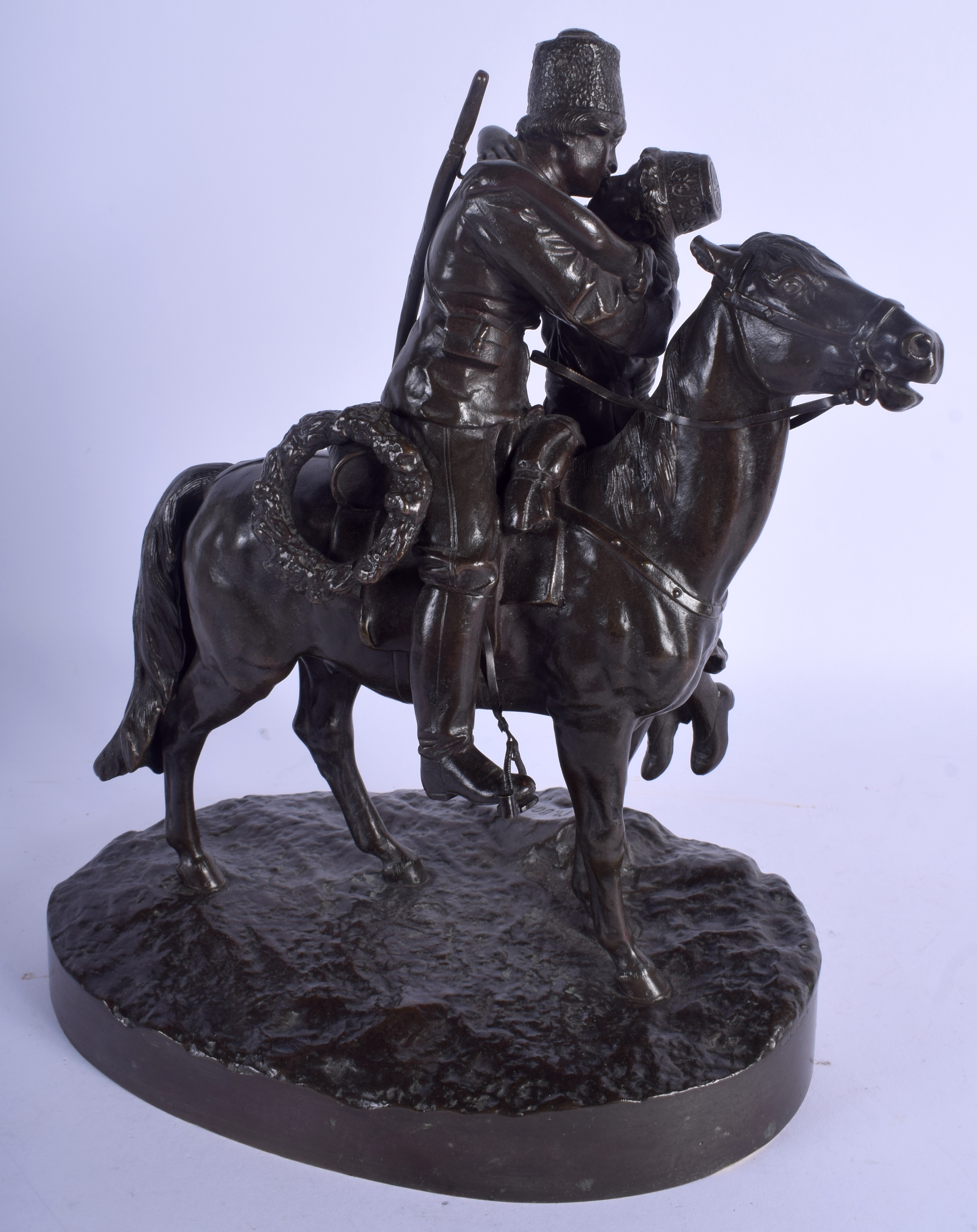 A 19TH CENTURY RUSSIAN BRONZE FIGURE OF A COSSACK AND FEMALE modelled upon a naturalistic base. 27