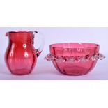 AN ANTIQUE CRANBERRY GLASS JUG and matching bowl. (2)