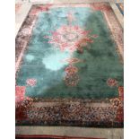 A Large country house Green Ground Persian rug. 542cm x 367cm