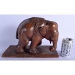 A LARGE ANTIQUE ANGLO INDIAN CARVED HARDWOOD FIGURE OF AN ELEPHANT modelled upon a rectangular base