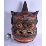 A RARE LARGE 19TH CENTURY POLYCHROMED WOOD TIBETAN RITUAL MASK modelled scowling with red pigmented