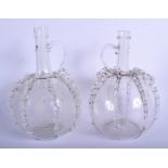 AN UNUSUAL PAIR OF ANTIQUE CONTINENTAL GLASS JUGS of bulbous form with rippled bodies. 24.5 cm high