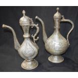 Two middle Eastern metal embossed ewers 40.5cm