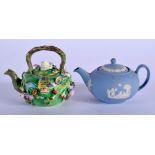 Wedgwood miniature teapot and cover in blue jasperware and a Coalbrookdale style floral encrusted m
