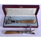 A RARE PAIR OF 19TH CENTURY CARVED RHINOCEROS HORN DRUM STICK HOLDERS one in a fitted case. 18 cm l