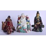 AN 18TH/19TH CENTURY CHINESE FAHUA POTTERY FIGURE OF AN IMMORTAL together with two others. Largest