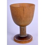 AN 18TH/19TH CENTURY GERMAN CARVED RHINOCEROS HORN EGG CUP with tapered shaft. 38 grams. 6.5 cm x 4