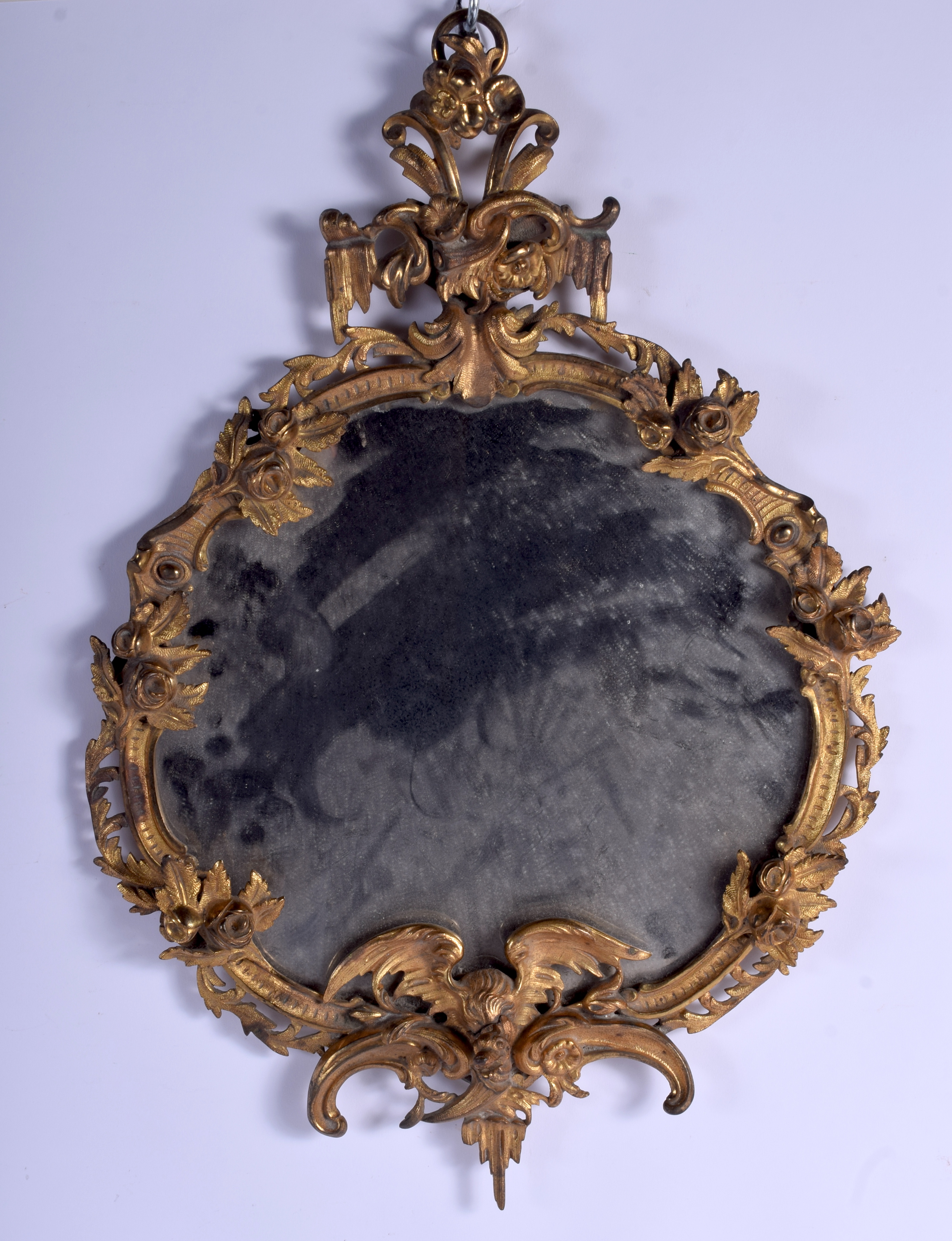 A 19TH CENTURY FRENCH GILT BRONZE MIRROR encased within foliage and a bird. 50 cm x 30 cm.