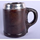 AN ANTIQUE CONTINENTAL SILVER MOUNTED LEATHER MUG with copper lining. 12 cm high.