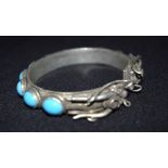 A Chinese White metal dragon Bangle with Turquoise stones