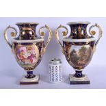 A PAIR OF EARLY 19TH CENTURY DERBY TWIN HANDLED VASES painted with European landscapes. 30 cm x 18