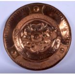 AN ARTS AND CRAFTS COPPER DISH decorated with floral roundels. 31 cm diameter.