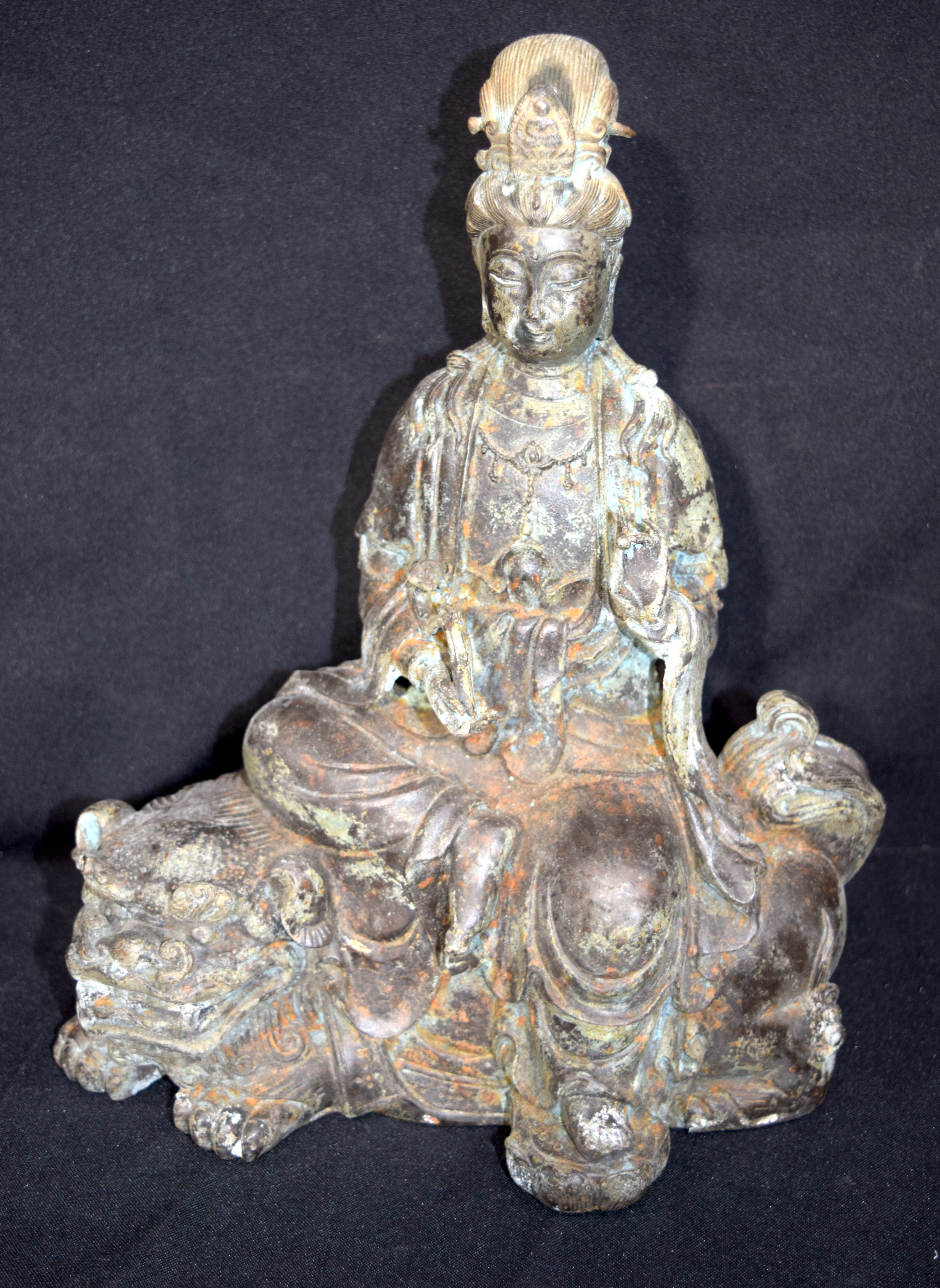 Chinese bronze Buddha seated on a beast. Buddha 28cm high