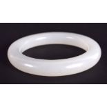 A CHINESE CARVED WHITE JADE CHILDS BANGLE 20th Century. 5.5 cm diameter.