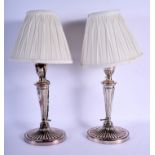 A PAIR OF ENGLISH SILVER PLATED CANDLESTICKS converted to lamps. Silver 31 cm high.