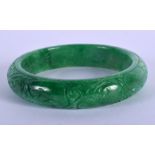 A CHINESE APPLE JADE BANGLE 20th Century. 7.5 cm wide.