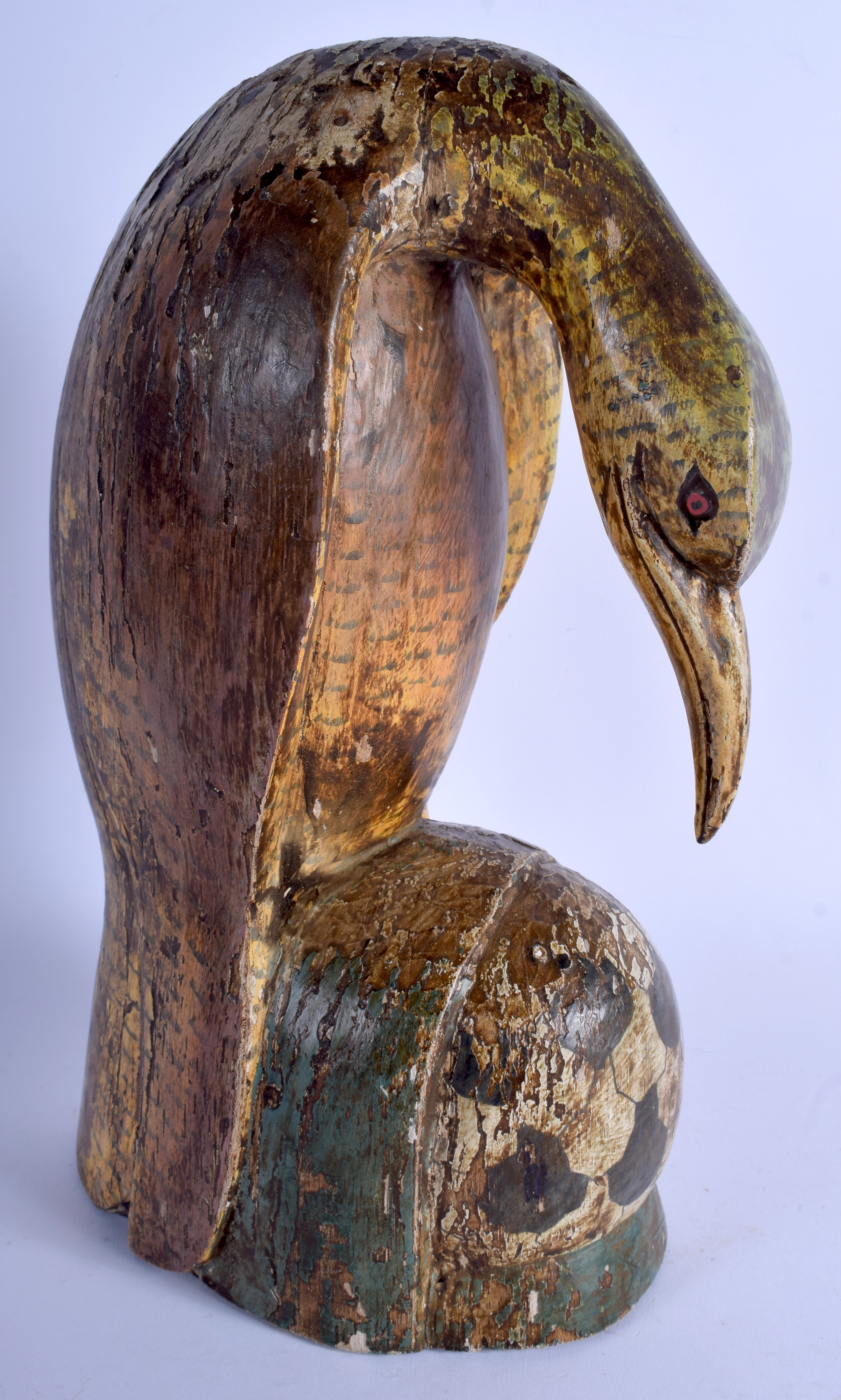 AN EARLY 20TH CENTURY INDO PERSIAN LACQUERED FIGURE OF A BIRD modelled leaning downwards. 32 cm x 1