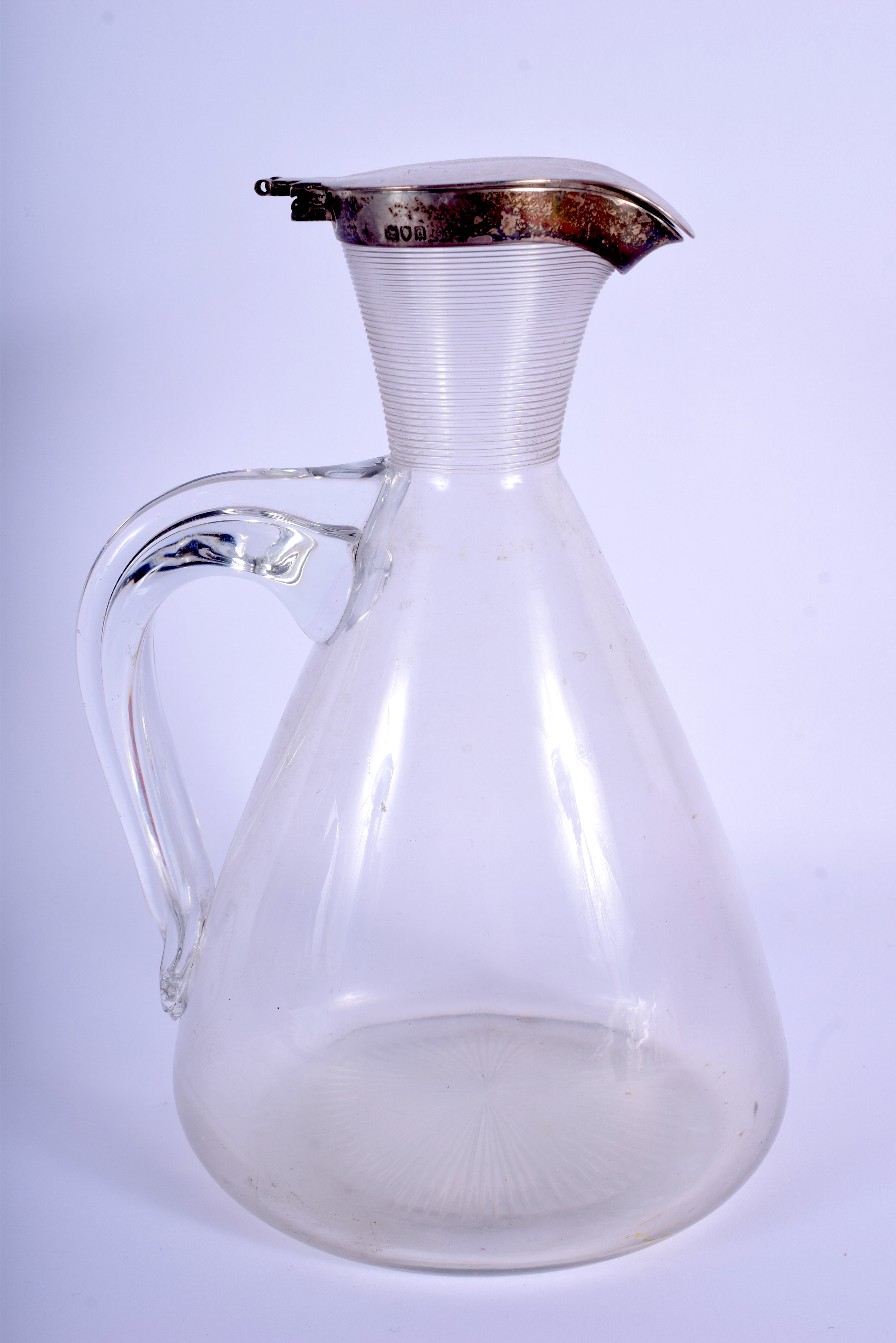 AN ARTS AND CRAFTS SILVER MOUNTED DECANTER. 21.5 cm high.