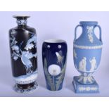 A WEDGWOOD BLUE BASALT TWIN HANDLED VASE together with two other vases. Largest 24 cm high. (3)