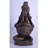 AN UNUSUAL SOUTH AMERICAN POTTERY FIGURE OF A FEMALE modelled with legs crossed. 27 cm high.