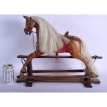 AN EARLY 20TH CENTURY EUROPEAN CARVED FOLK ART WOOD ROCKING HORSE upon an oak plinth. 44 cm x 30 cm