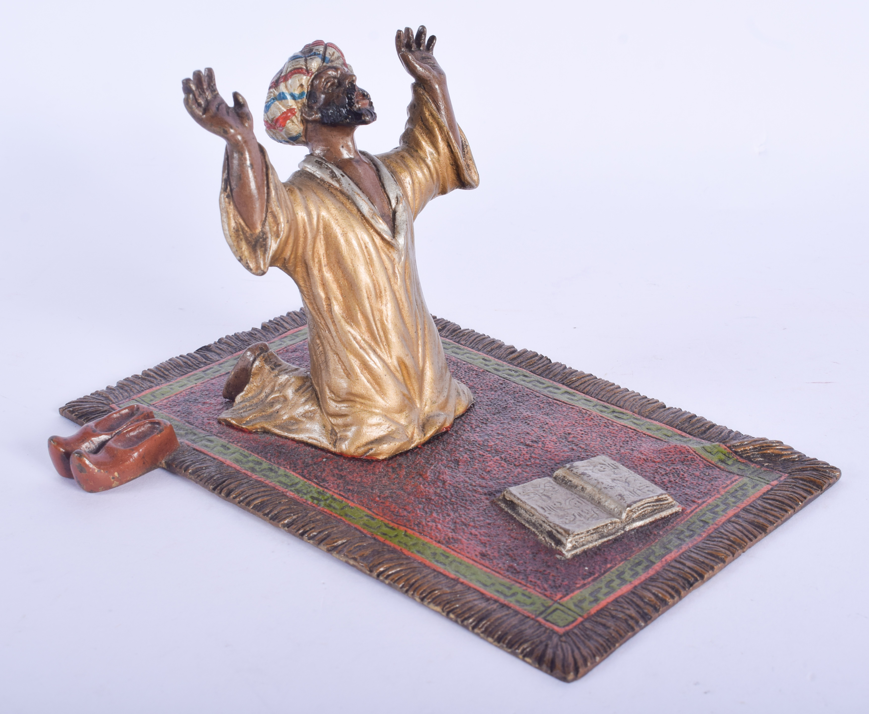 A 19TH CENTURY AUSTRIAN COLD PAINTED BRONZE FIGURE OF AN ARABIC MALE modelled praying upon a rug. 1