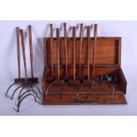A RARE EARLY 20TH CENTURY TABLE CROQUET SET within a fitted box. 26 cm wide. (qty)
