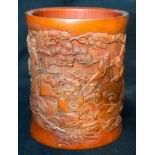 A Chinese bamboo brush pot carved with figures in a land scape 16cm