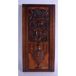 AN ARTS AND CRAFTS CARVED WOOD PANEL depicting an urn with emerging foliage. 50 cm x 14 cm.