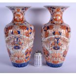 A LARGE PAIR OF 19TH CENTURY JAPANESE MEIJI PERIOD RIBBED IMARI VASES painted with flowers. 45 cm h