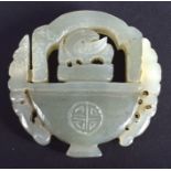 AN UNUSUAL CHINESE CARVED GREEN JADE SWIVEL PLAQUE 20th Century. 4.5 cm x 3.25 cm.