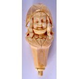 A 19TH CENTURY FRENCH CARVED IVORY CANE HANDLE modelled as a female wearing a hat. 10 cm x 3.5 cm.