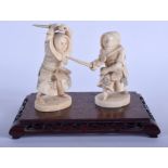A PAIR OF 19TH CENTURY JAPANESE MEIJI PERIOD CARVED IVORY SAMURAI modelled upon a hardwood base. Fi