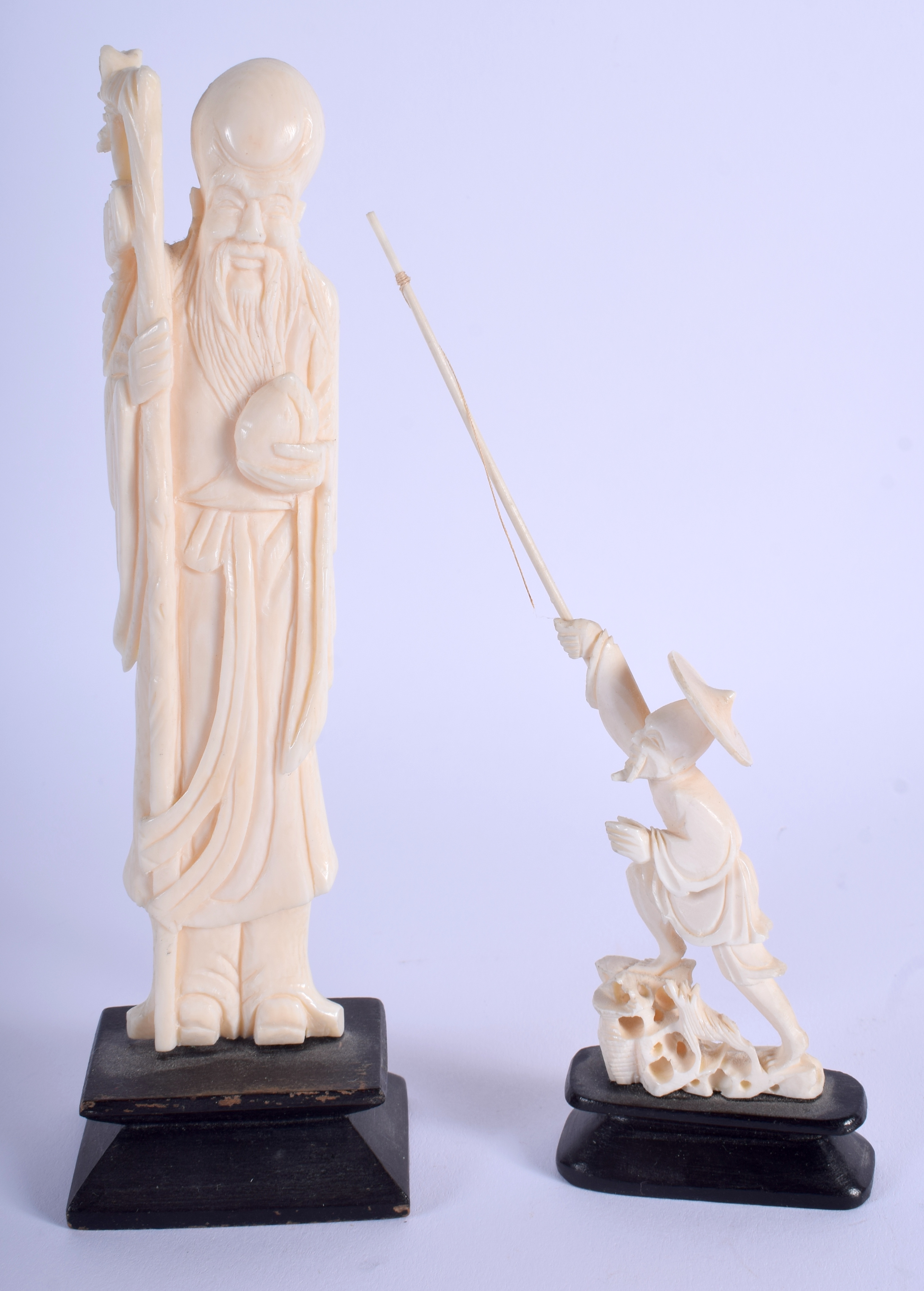 AN EARLY 20TH CENTURY CHINESE CARVED IVORY IMMORTAL together with another. Largest ivory 14 cm high