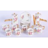 AN EARLY 20TH CENTURY FRENCH LIMOGES PORCELAIN COFFEE SET painted with floral sprays. Largest 17 cm
