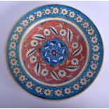 A TURKISH MIDDLE EASTERN FAIENCE POTTERY DISH painted with floral sprays. 21 cm diameter.