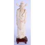 A SMALLER EARLY 20TH CENTURY CHINESE CARVED BONE FIGURE OF A SCHOLAR modelled holding his belt. Iv