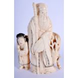 A 19TH CENTURY JAPANESE MEIJI PERIOD CARVED IVORY OKIMONO modelled as a scholar beside a deer. 14 c