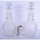 A LARGE PAIR OF ANTIQUE CRYSTAL GLASS DECANTERS AND STOPPERS. 40 cm high.