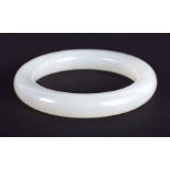 A CHINESE CARVED WHITE JADE CHILDS BANGLE 20th Century. 5.5 cm diameter.