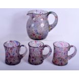 AN UNUSUAL VINTAGE ART GLASS PITCHER with three matching glasses. Largest 16 cm x 12 cm. (4)
