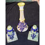 A large ceramic Mexican Vase together with matching candle holders decorated with grapes