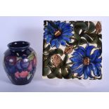 A MOORCROFT VASE together with a tile. Largest 15 cm square. (2)