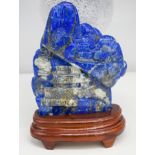 A Lapis lazuli carved boulder with stand 17 x 13 cm