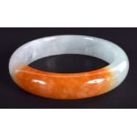 A CHINESE CARVED TRI COLOUR JADEITE BANGLE 20th Century. 7 cm diameter.