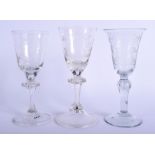 THREE 18TH CENTURY CONTINENTAL WINE GLASSES engraved with crests and figures. Largest 18 cm high. (
